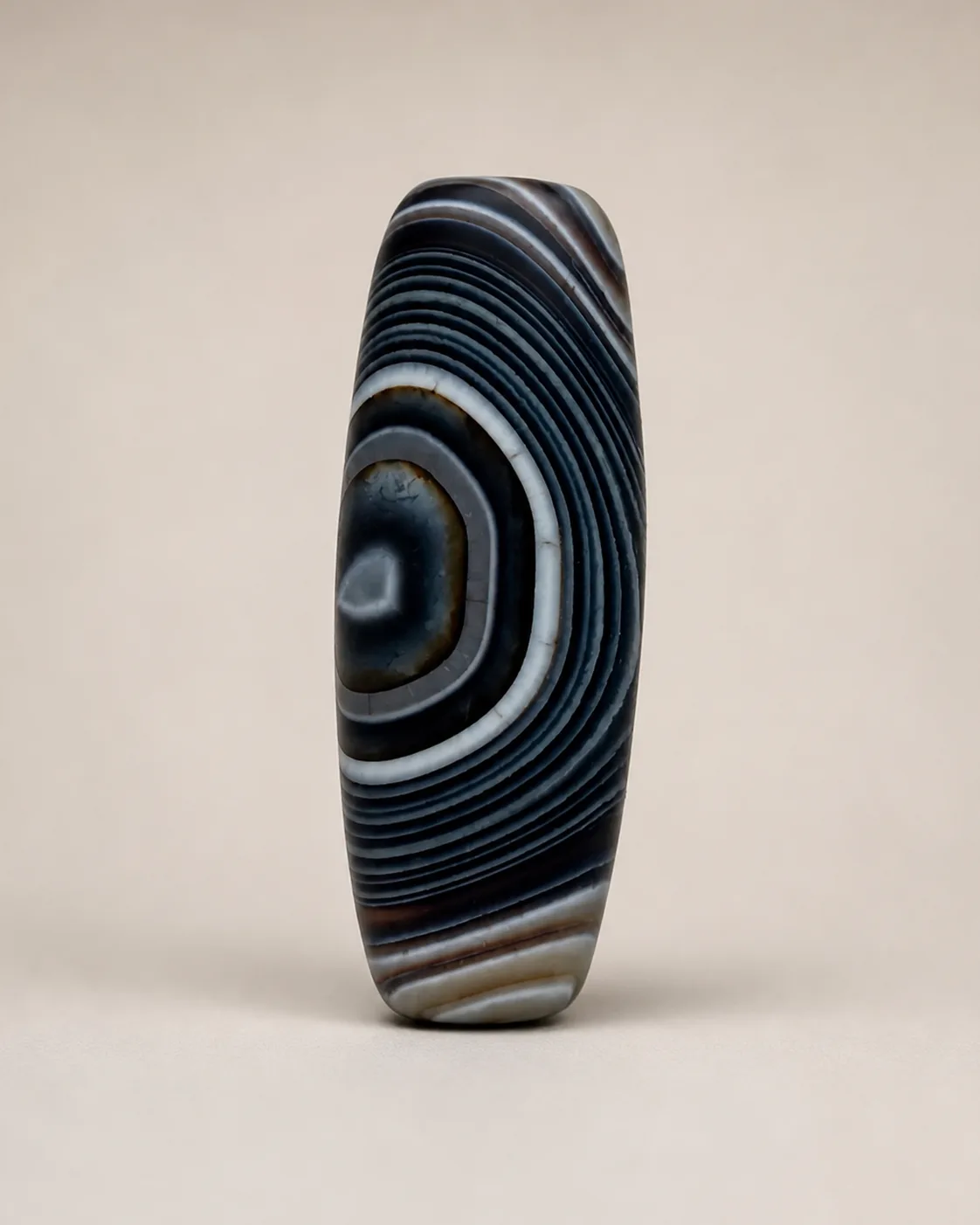 Banded Agate Dzi Bead with bold concentric arch bands — approx. 37.3 × 14.8 mm | Front