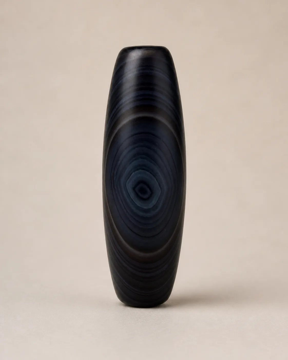 Banded Agate Dzi Bead with dark concentric oval bands — approx. 41.2 × 14.3 mm | Front
