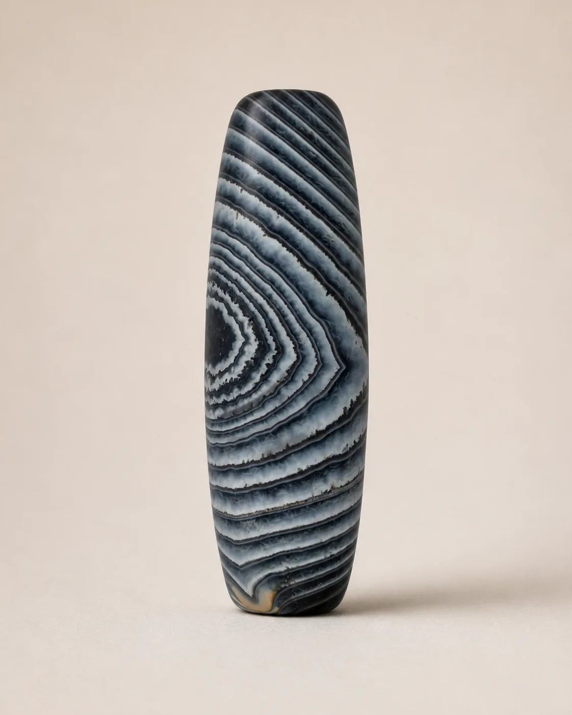Banded Agate Dzi Bead with dense nested triangular layers — approx. 42.2 × 14.1 mm | Front