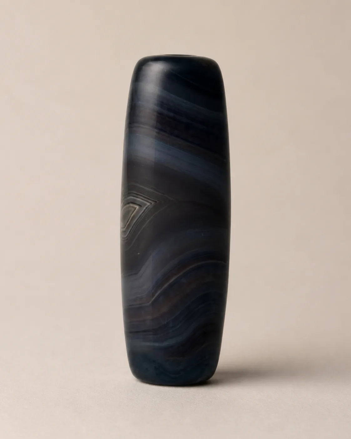 Banded Agate Dzi Bead with low-contrast angular layers on a blue-black field — approx. 42.4 × 15.4 mm | Front