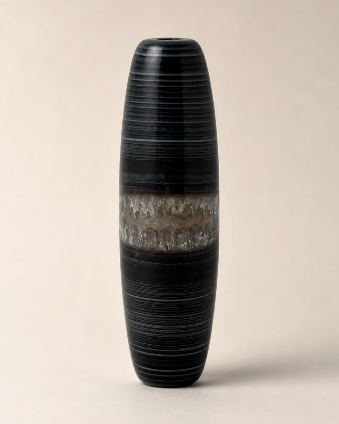Banded Agate Dzi Bead with fine dark parallel lines interrupted by a contrasting central band — approx. 50 × 14.9 mm | Front