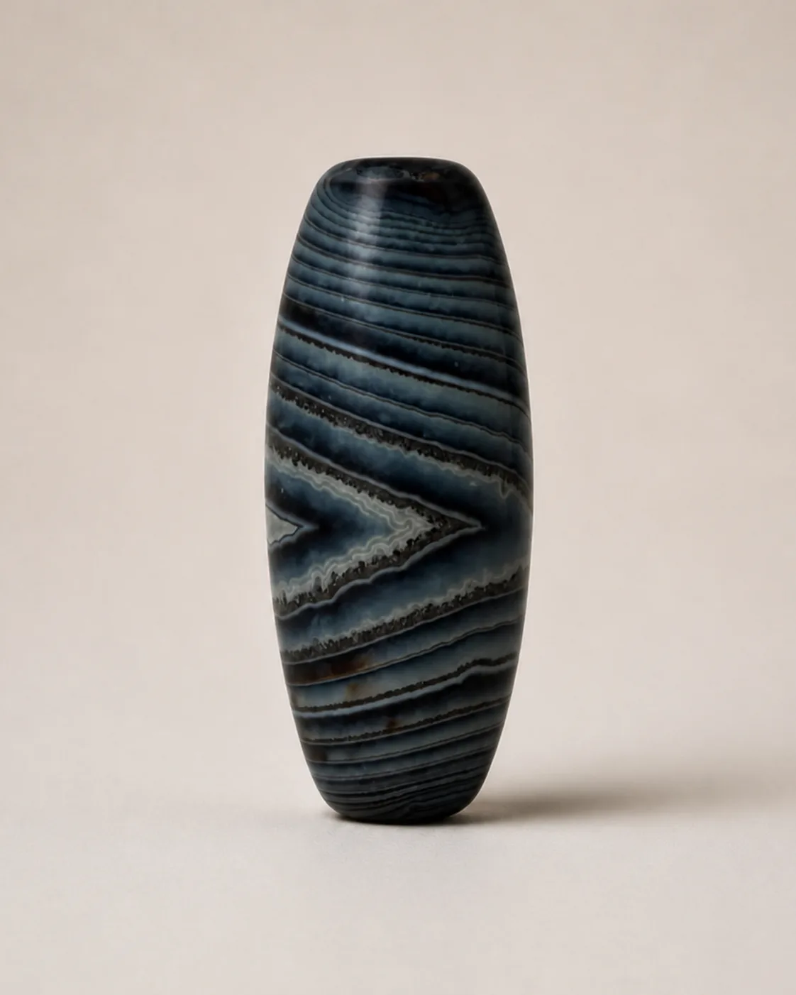 Banded Agate Dzi Bead with dense grey-blue layers around a pointed central field — approx. 33.8 × 17.2 mm | Front