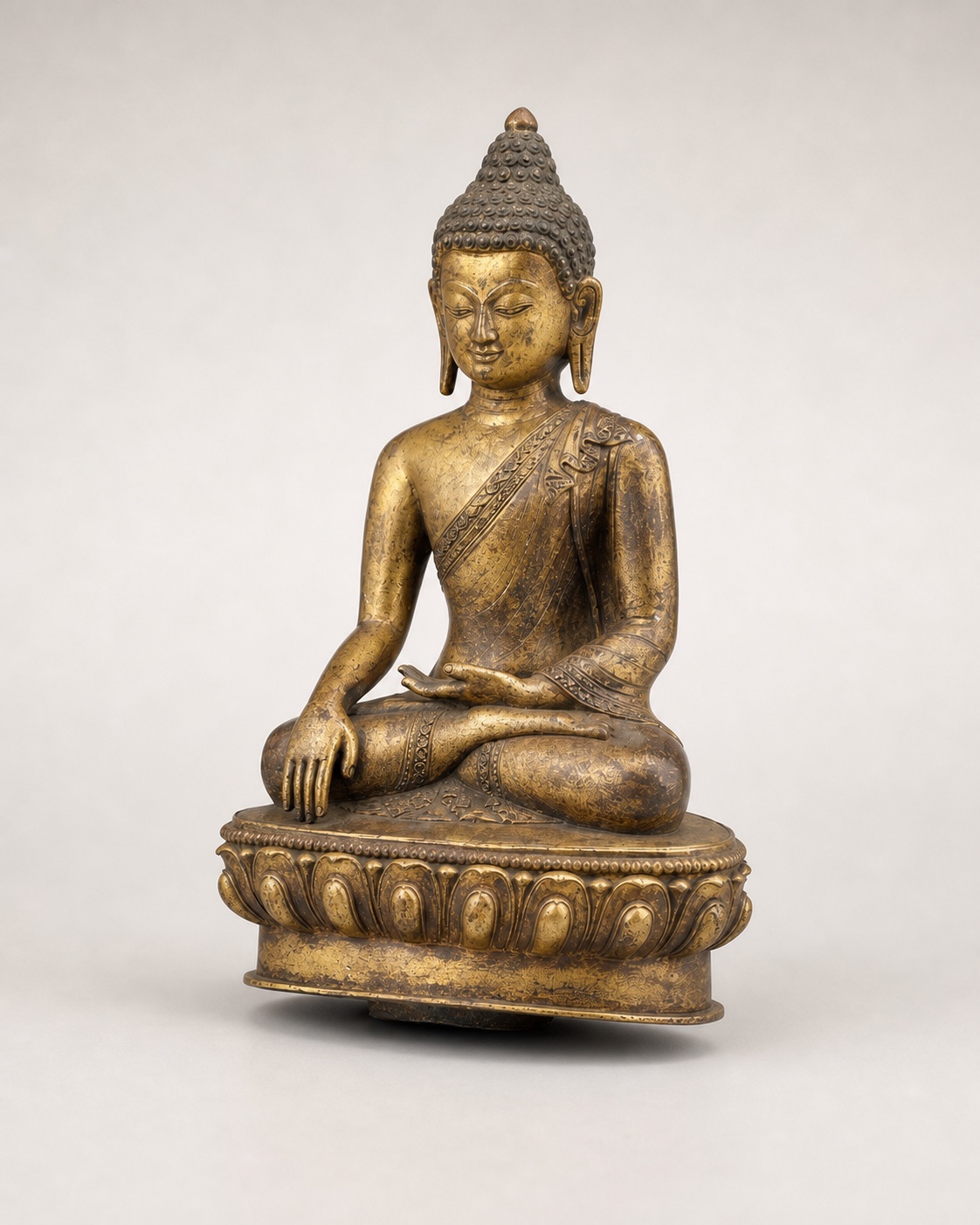 Copper-alloy figure with a gold-coloured surface in a three-quarter studio view