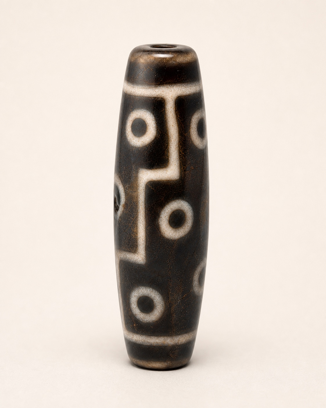 Patterned agate bead in a clear front studio view