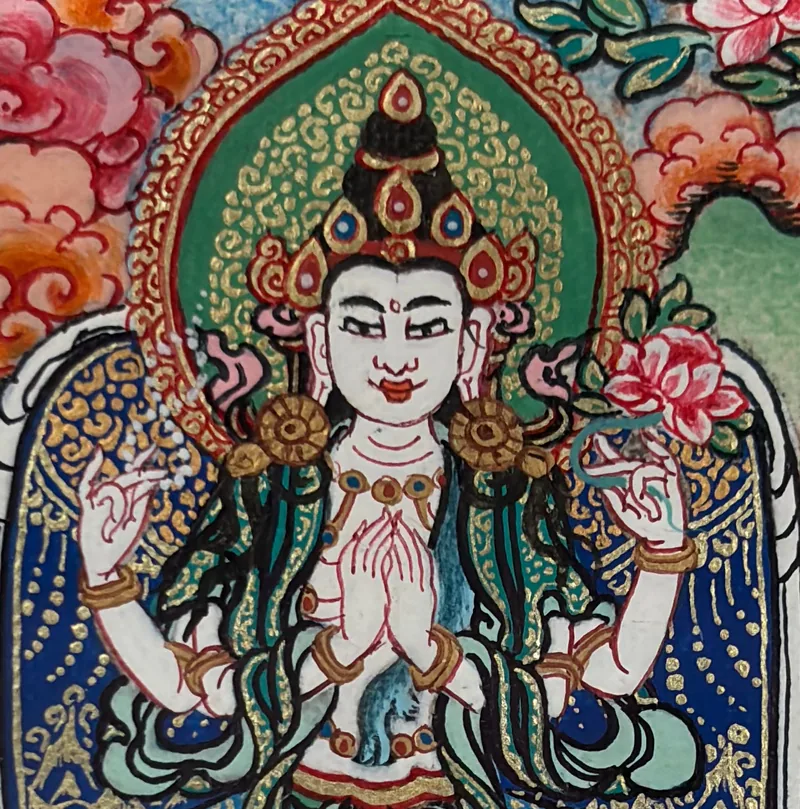 Close detail of a four-armed Avalokiteshvara miniature: face, joined hands and crown