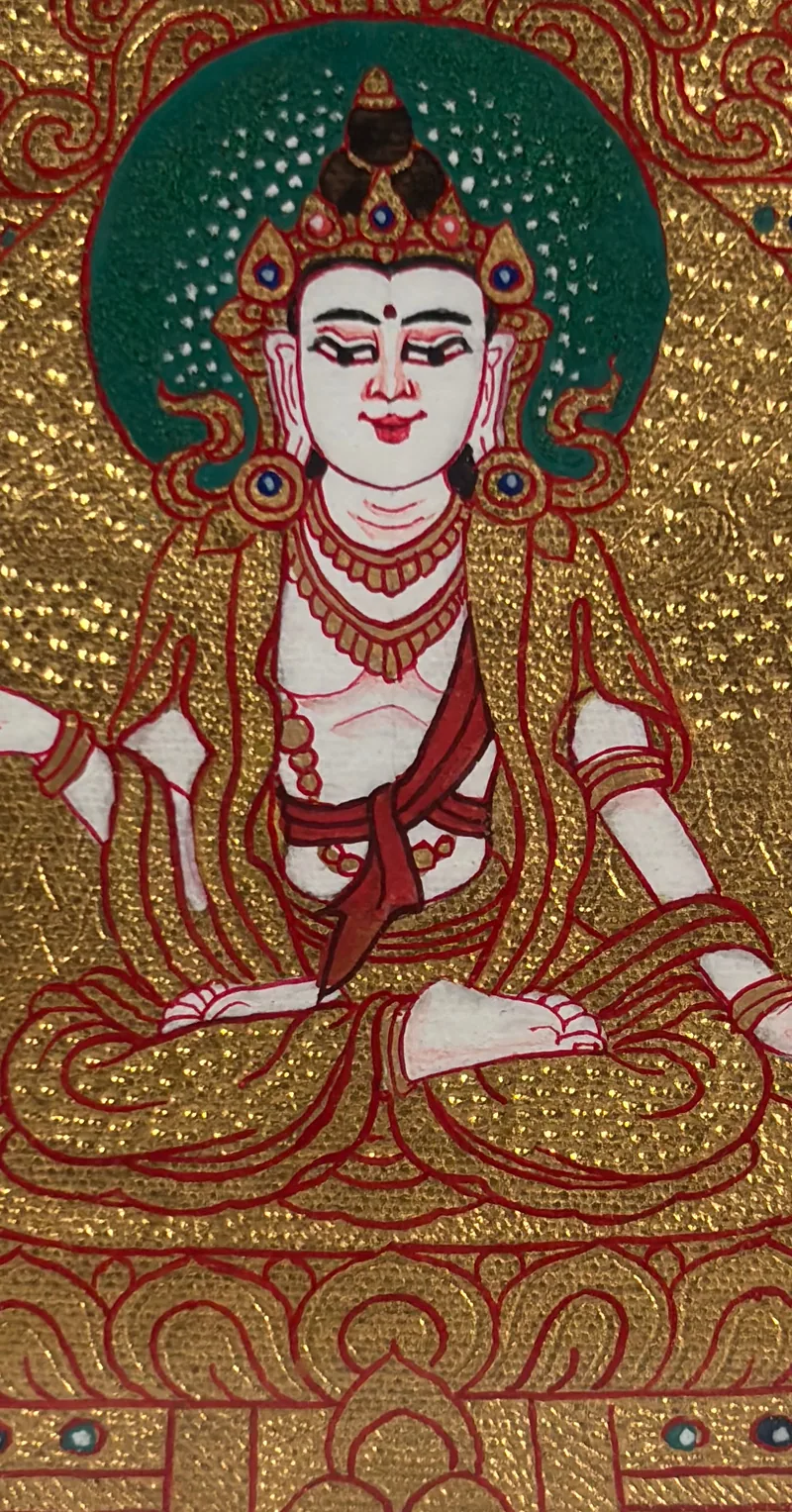 Detail view of a gold-ground miniature thangka with a white lotus-bearing figure