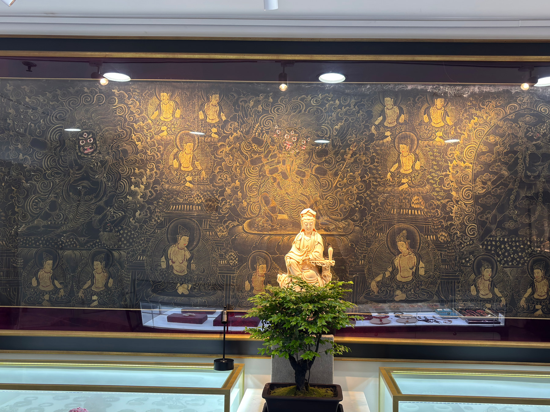A large wall work, display cases and three-dimensional objects