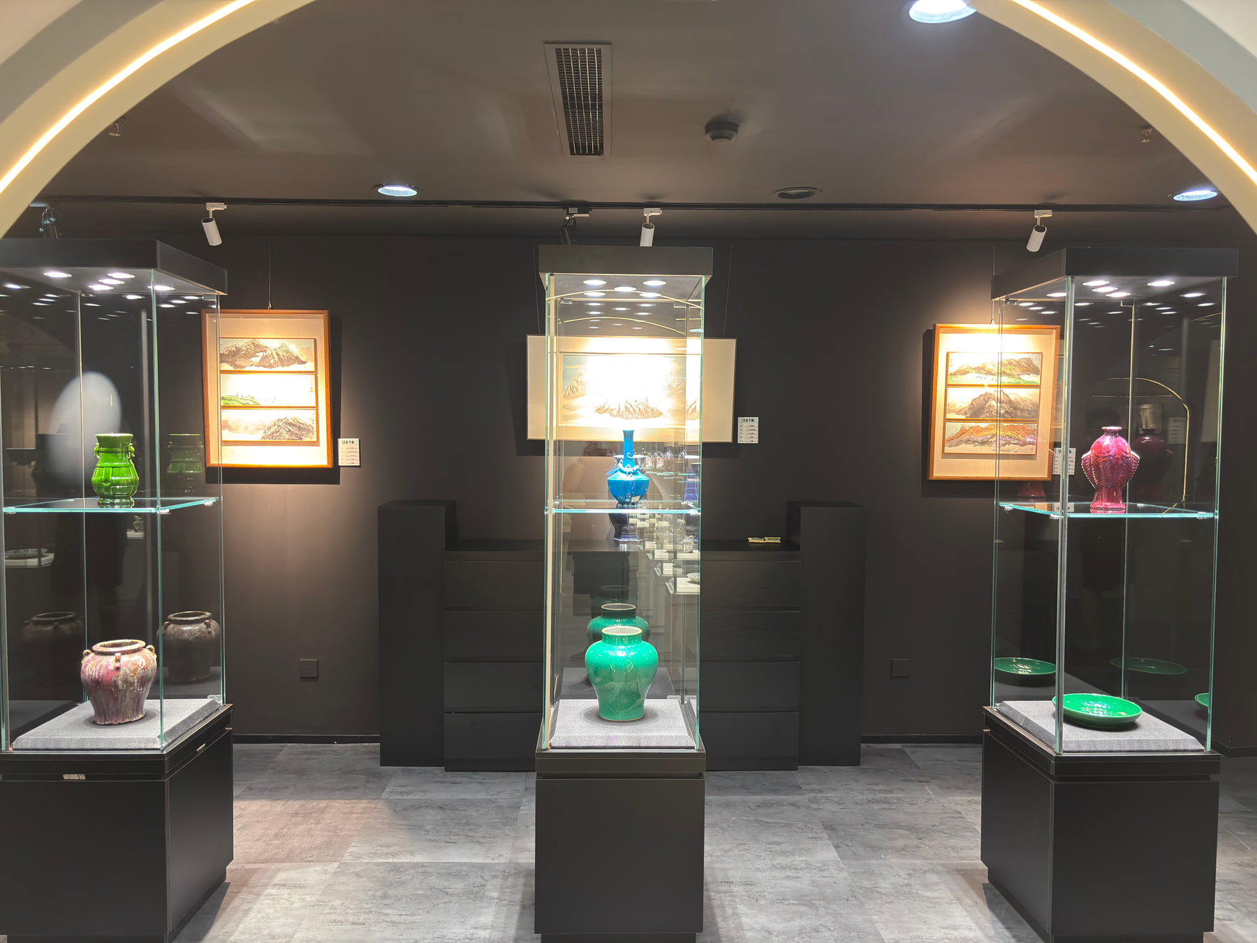 Objects displayed in a dark gallery