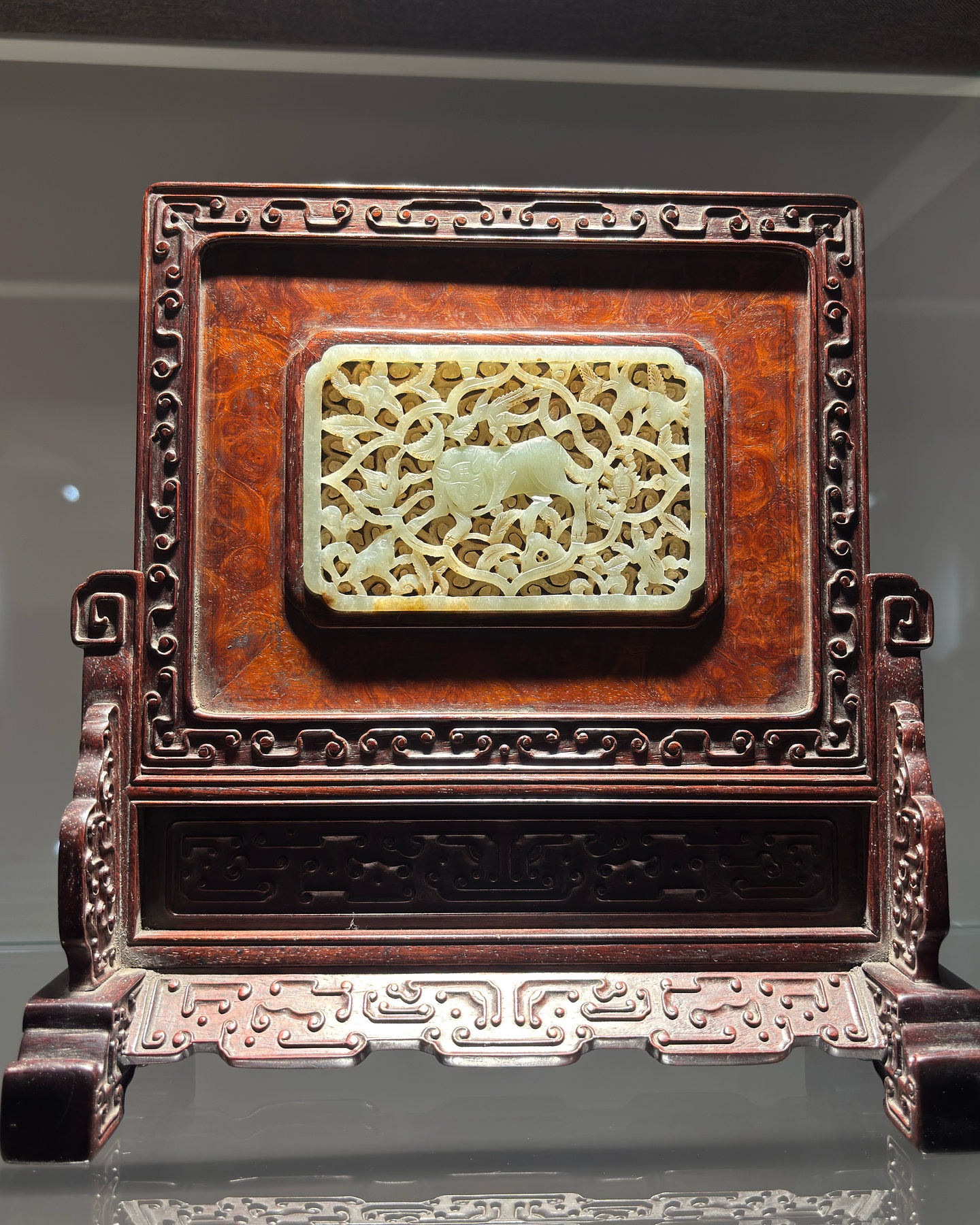 An openwork carving in a frame, with layered patterns and fine detail