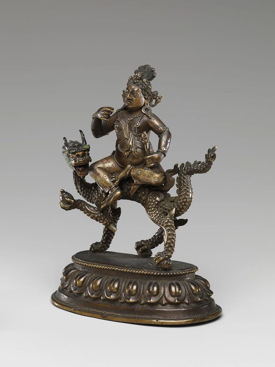 Angled view of White Jambhala on a dragon, showing the figure, hands and dragon mount