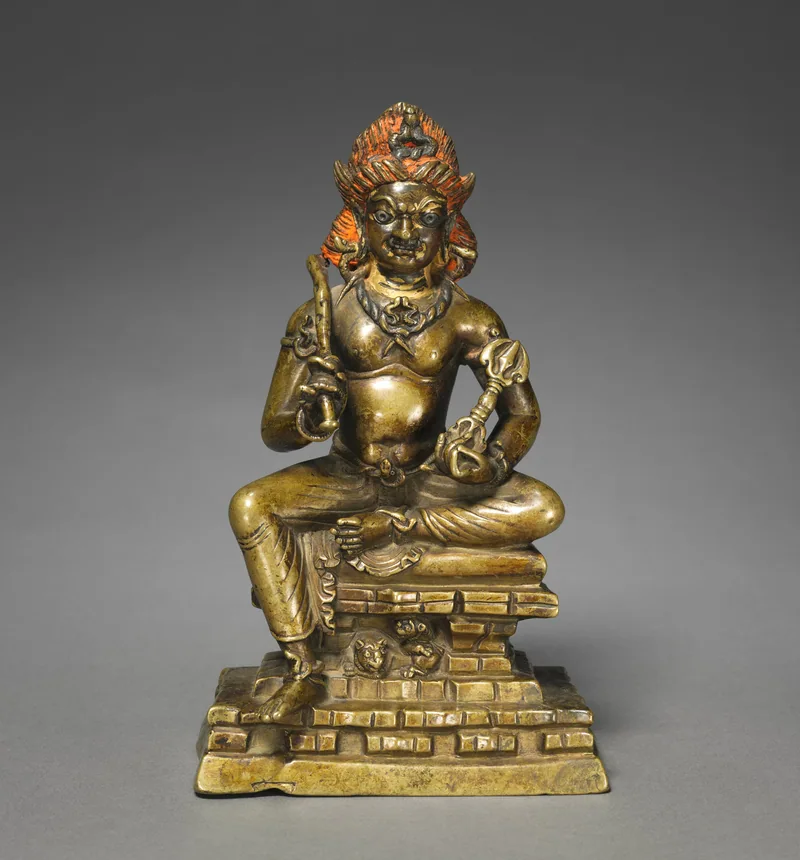 Vajrapani seated with a vajra and bell, raised reddish hair and lions in the base