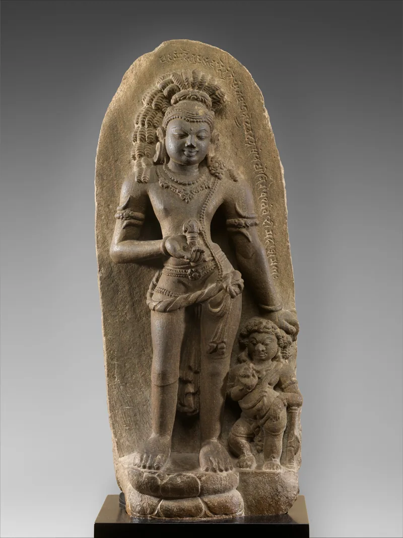 Standing Vajrapani raising a vajra, with a small attendant below the other hand