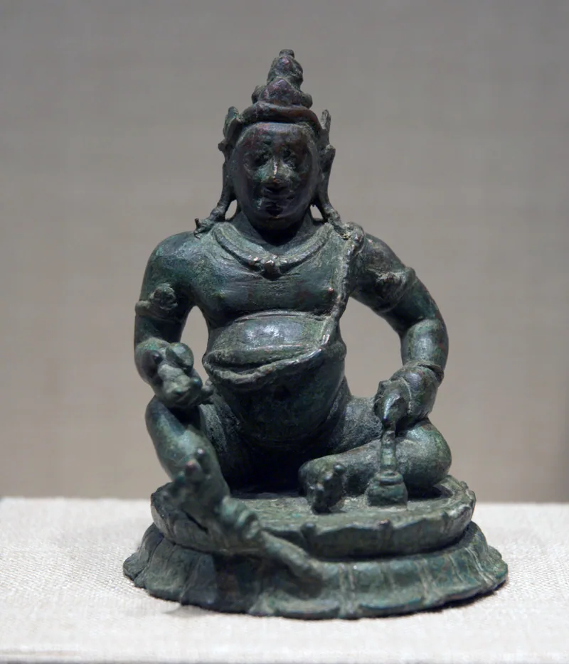 Small copper-alloy Jambhala from Sri Lanka with a rounded belly and smiling face
